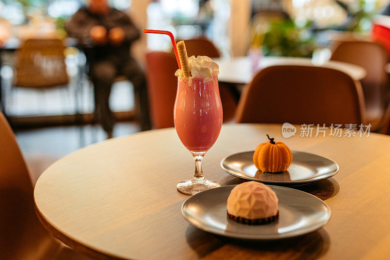 Mini Cakes And A Strawberry Milkshake On The Table In A Café